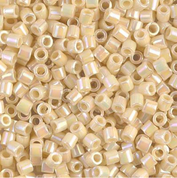 A dense pile of small cylindrical seed beads with a glossy, iridescent pearlescent finish in a light cream or champagne color.