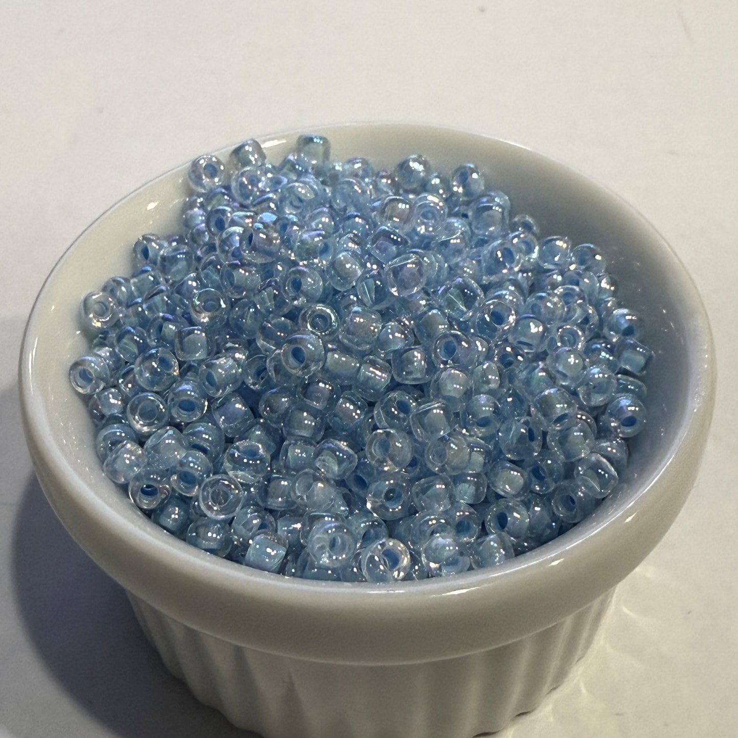 Dyna-Mites™ 8/0 Round Hole Transparent Ice Blue Rainbow 8328SB Seed Beads - 5 or 10 gm
