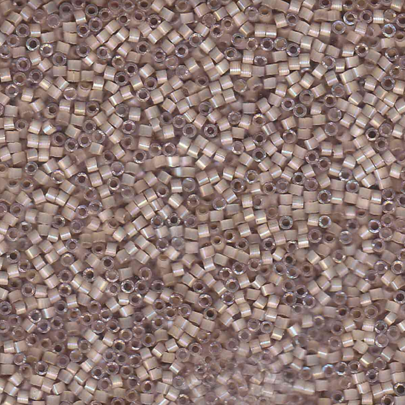 Close-up of small, round, beige delica beads arranged in a pattern