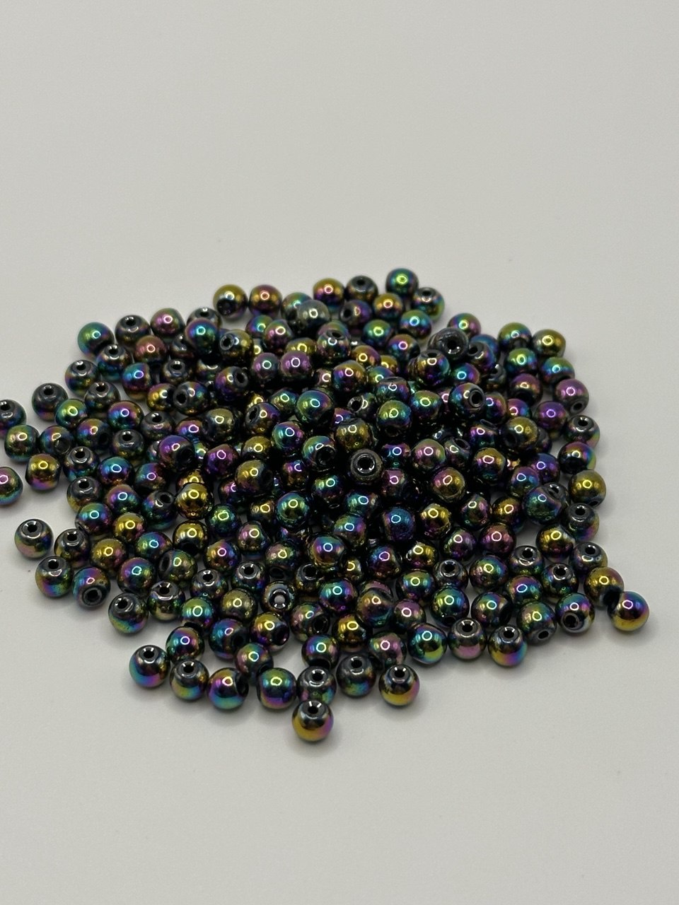 Multicolored hematite beads on a light gray background