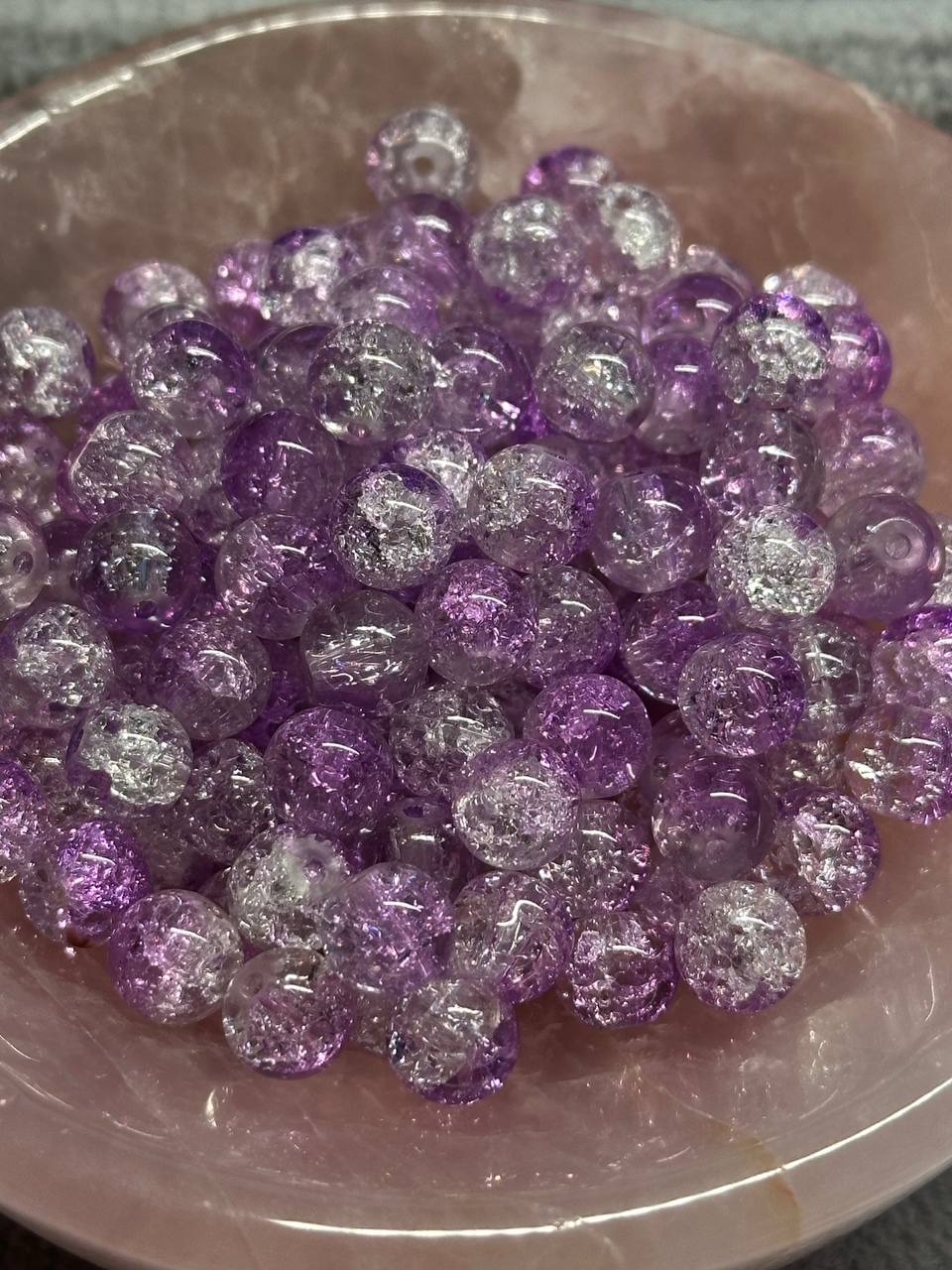 Purple and silver glittery beads on a pink plate