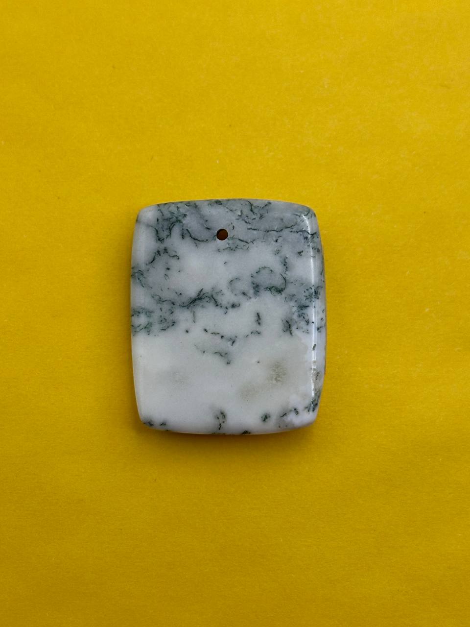 Marble-patterned stone on a yellow background