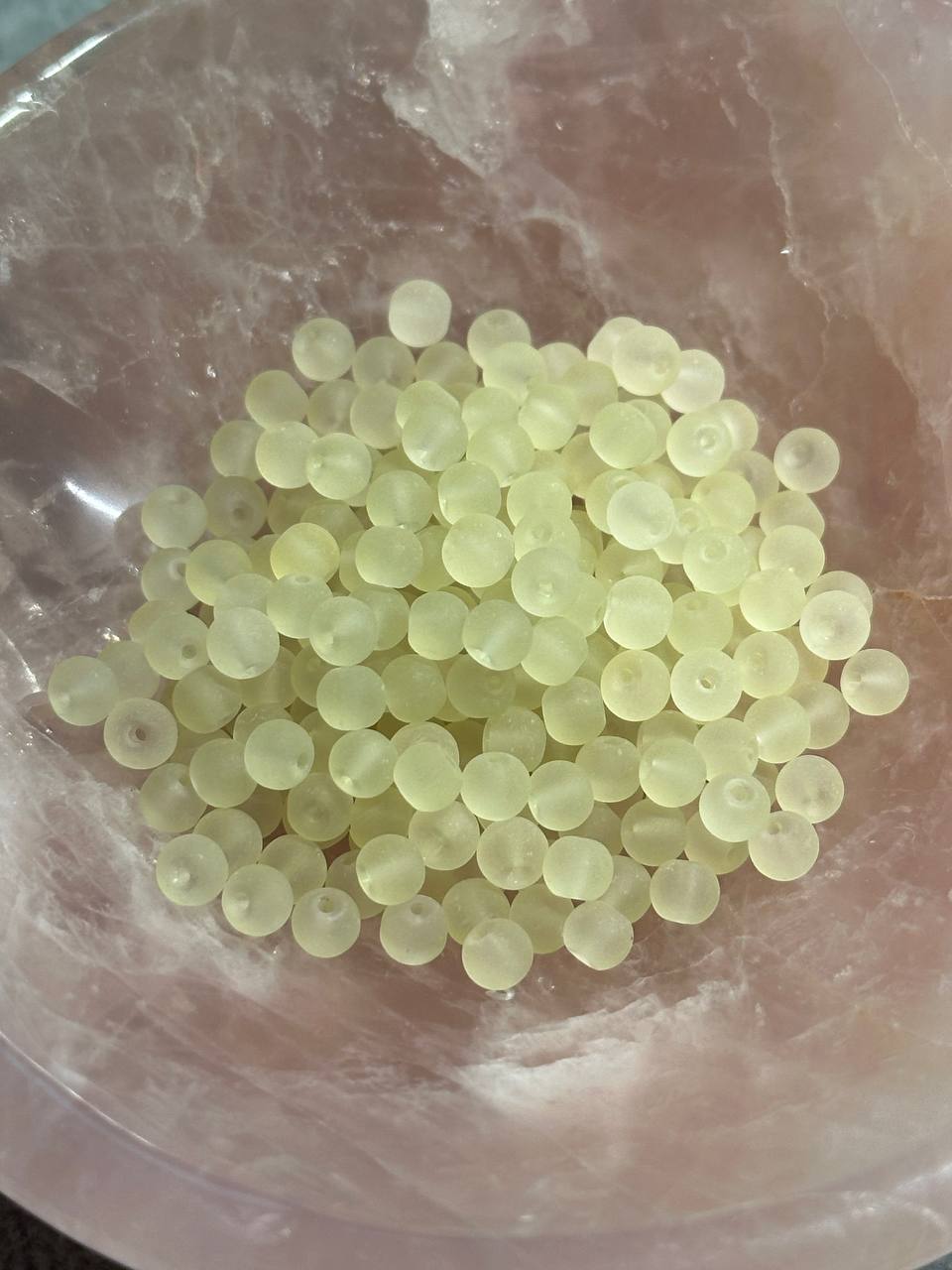 Yellow beads on a marble surface