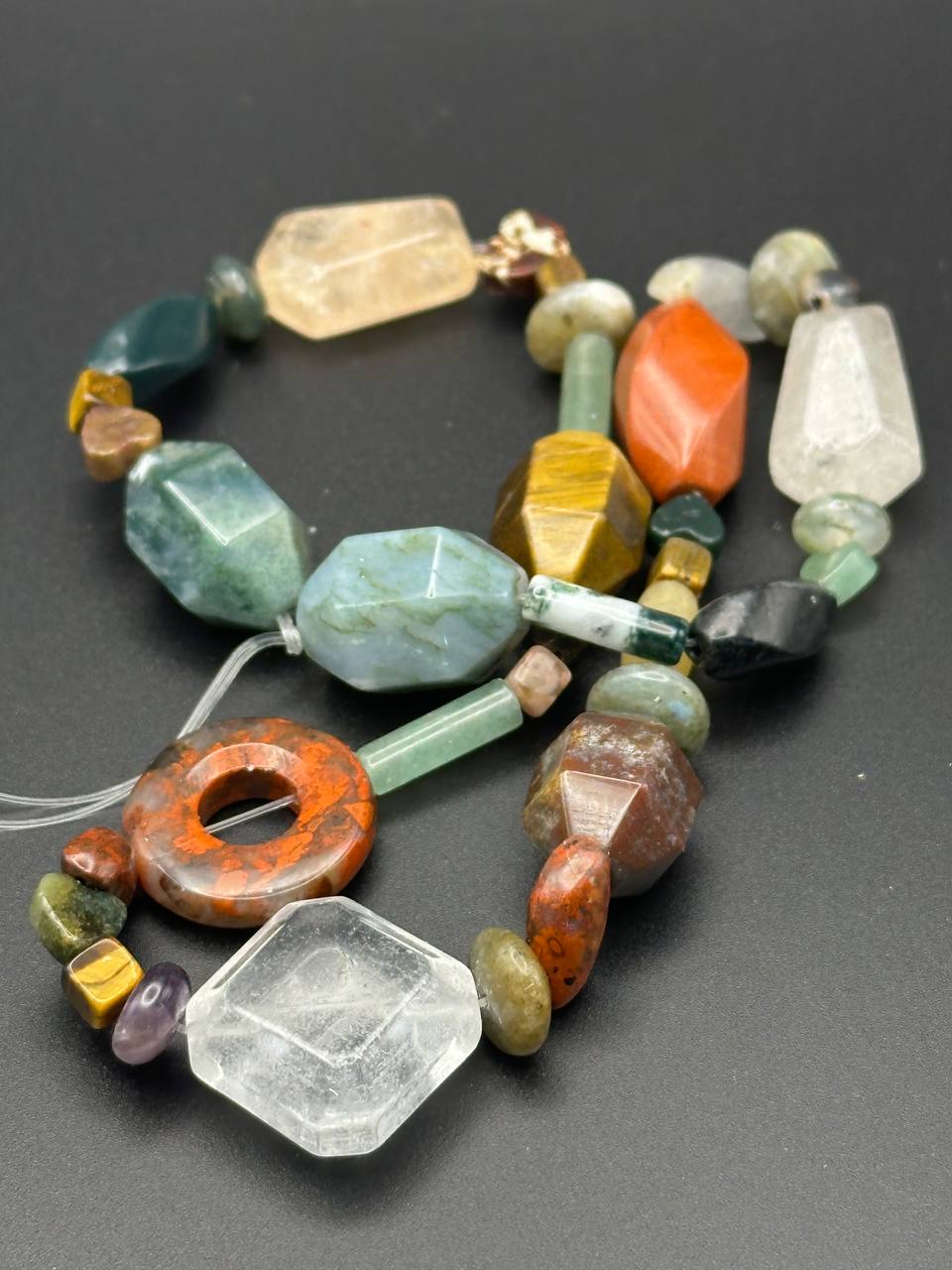 Necklace with multicolored beads on a dark background