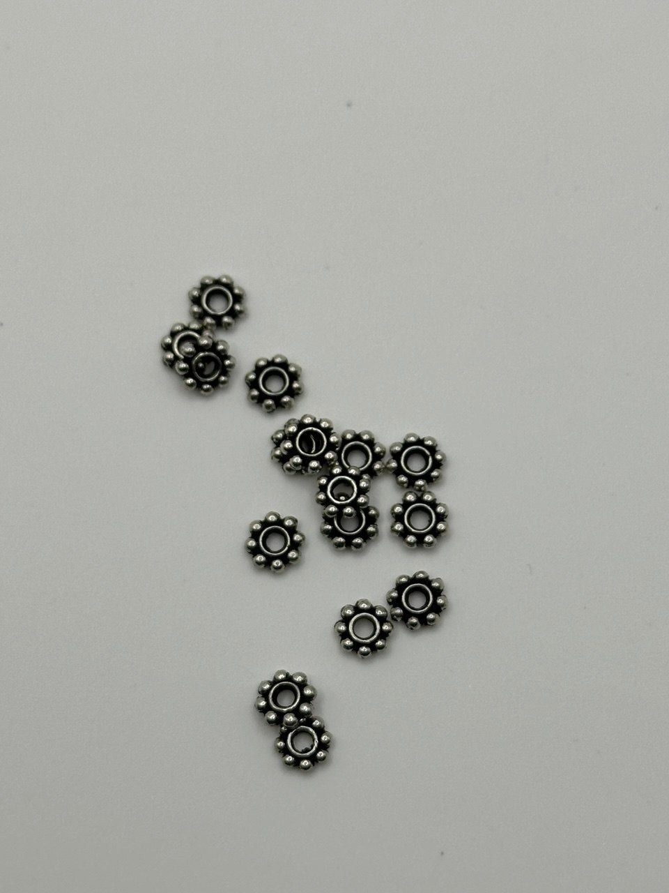 Small metal spacers on a gray background