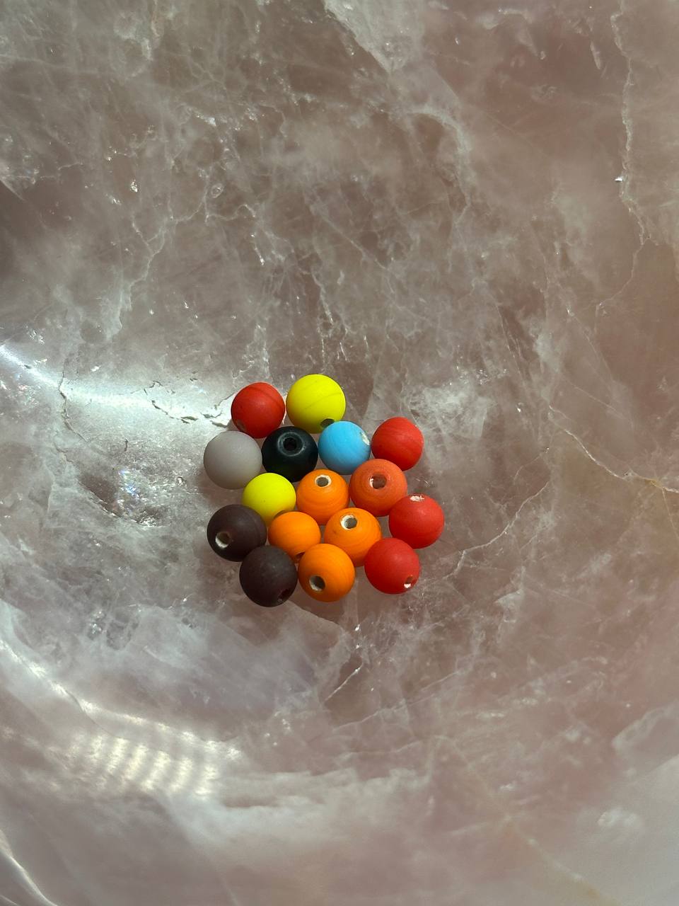 Colorful beads on a marble surface