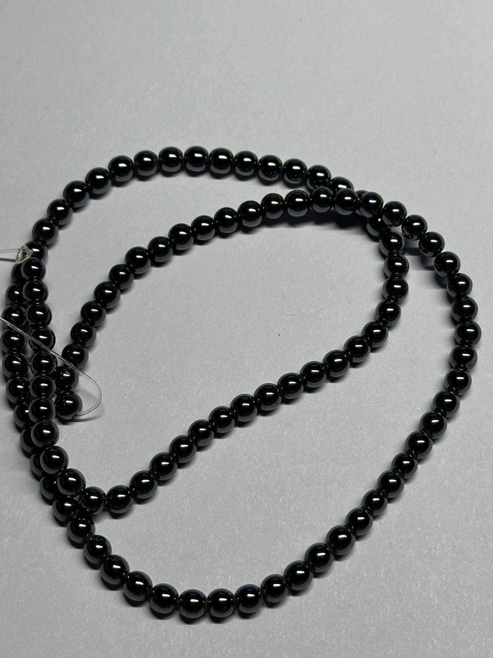 black hematite beads on grey surface