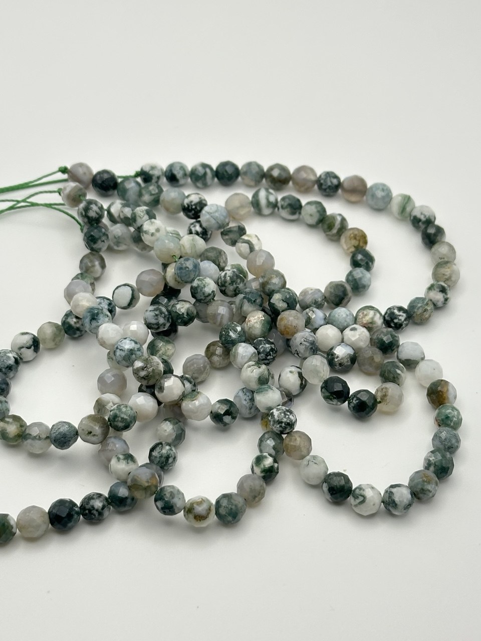 String of multicolored beads on a white background