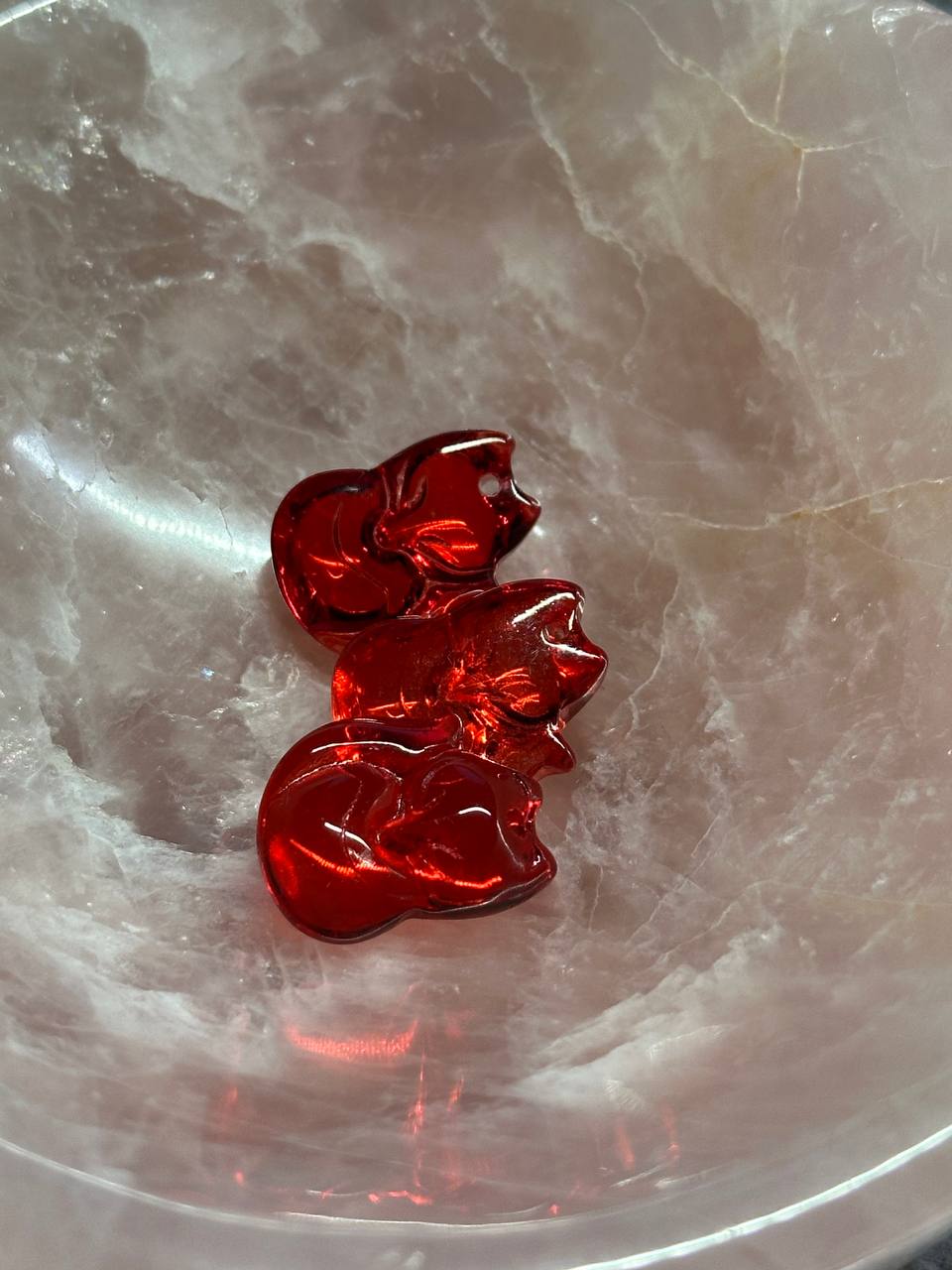 Red decorative item on a marble surface