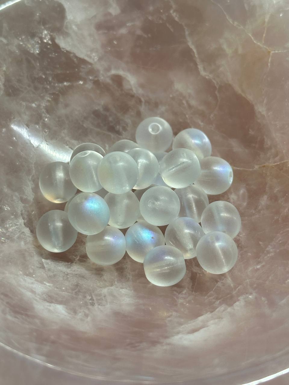 White AB beads on a marble surface