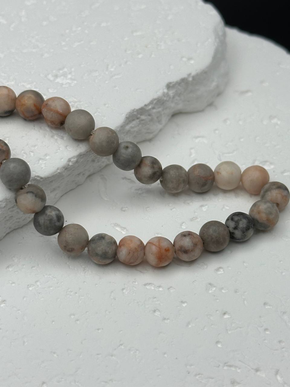 Picasso stone beads on white surface
