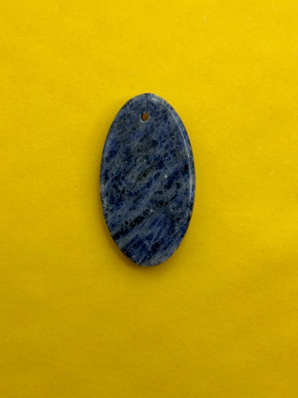 Blue oval stone pendant on a yellow background