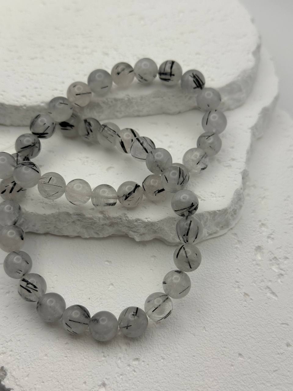 White and grey quartz beads on white surface