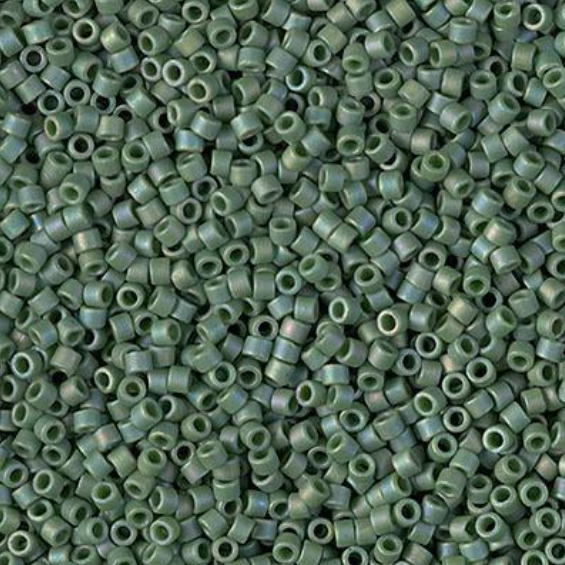 A close-up, top-down view of numerous small metallic green seed beads densely packed together.