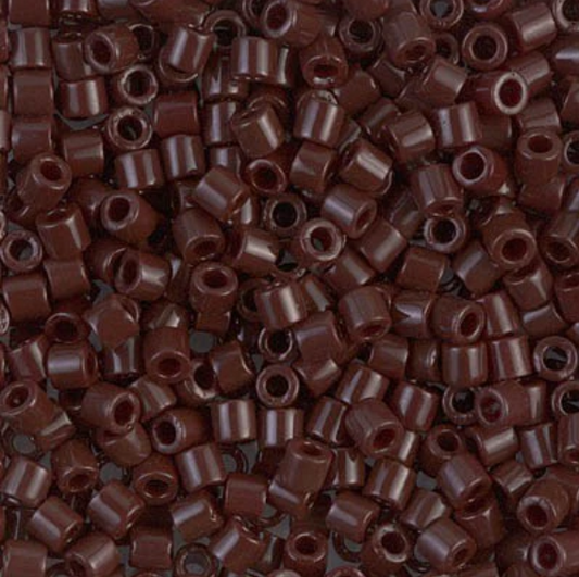 A dense pile of small cylindrical seed beads in a glossy dark reddish-brown color, filling the entire frame.