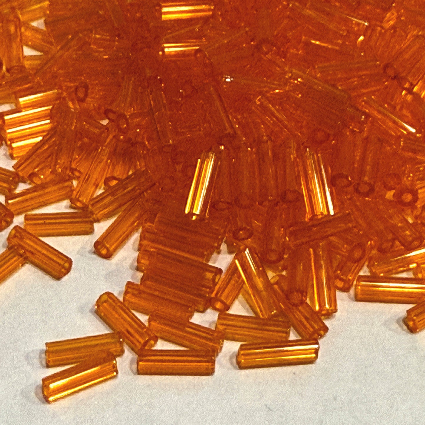 Preciosa #3 - 6-7 mm 90000 Transparent Orange Glass Bugle Beads - 5 gm