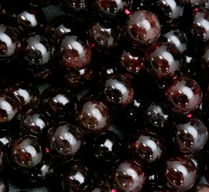 Close-up of dark red beads with a glossy finish