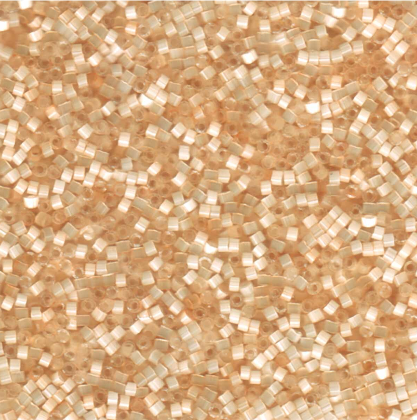Close-up of small satin delica beads in a beige color pattern