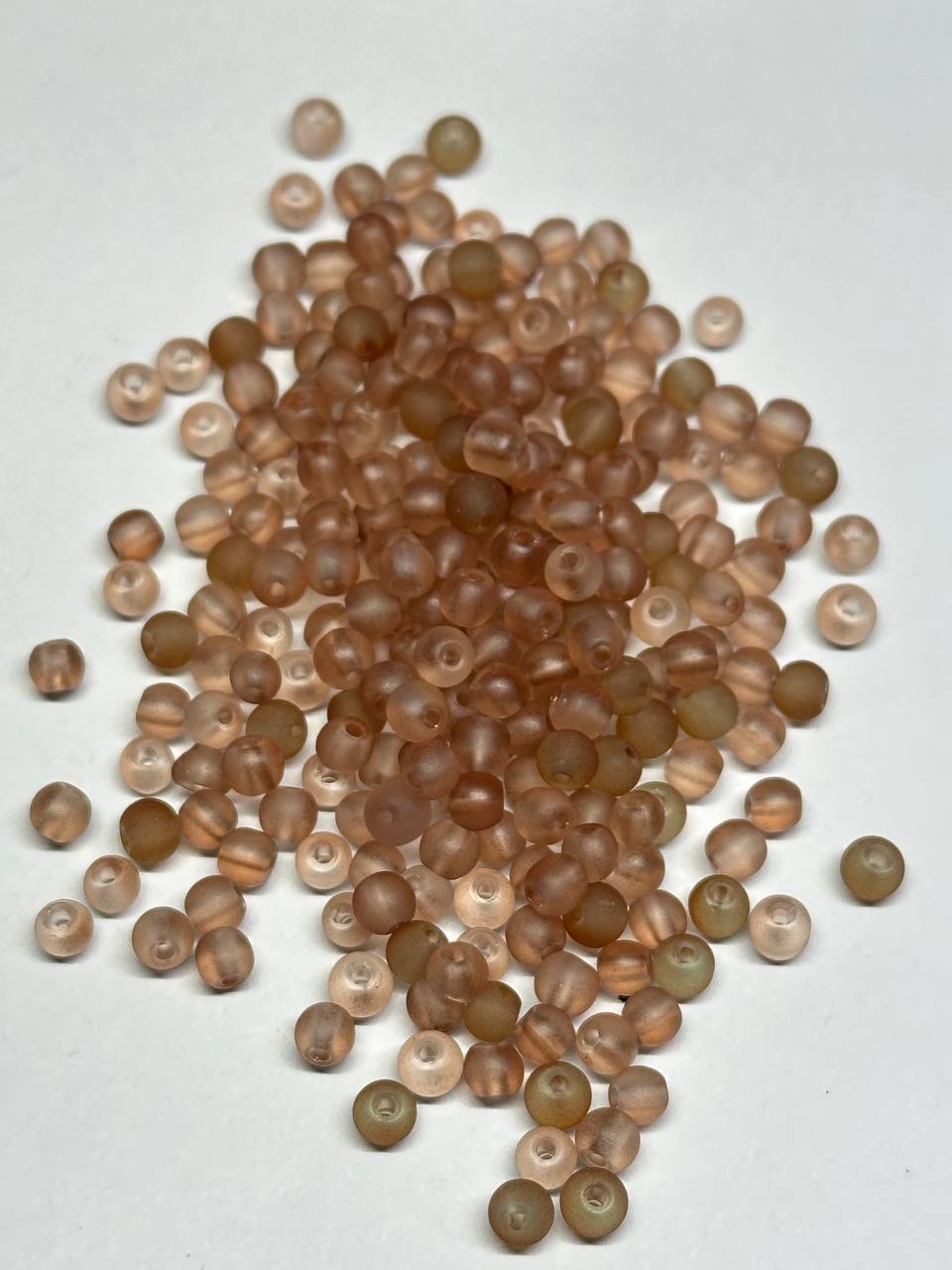 brown beads on white surface