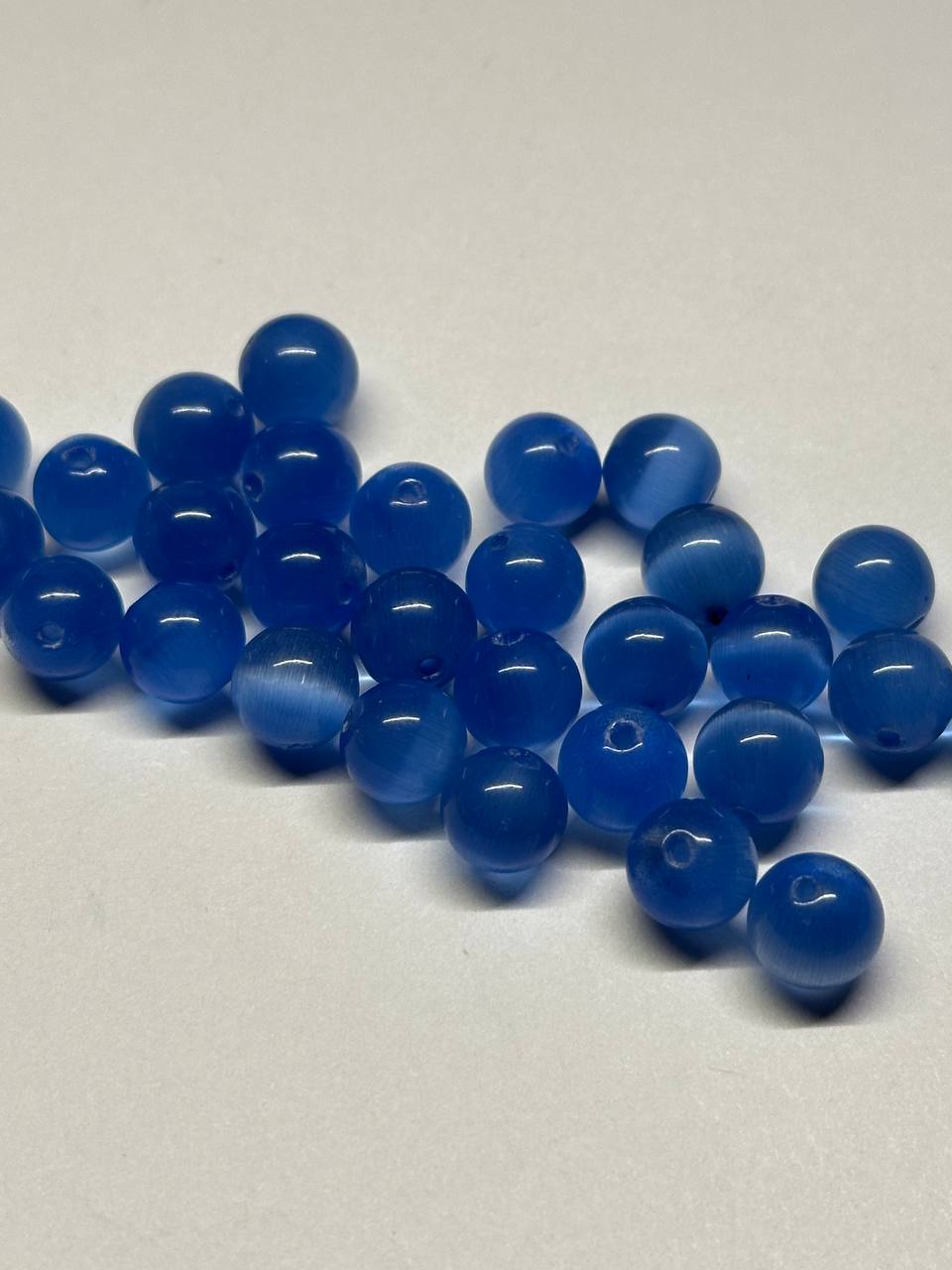 Blue cat eye beads on a white background
