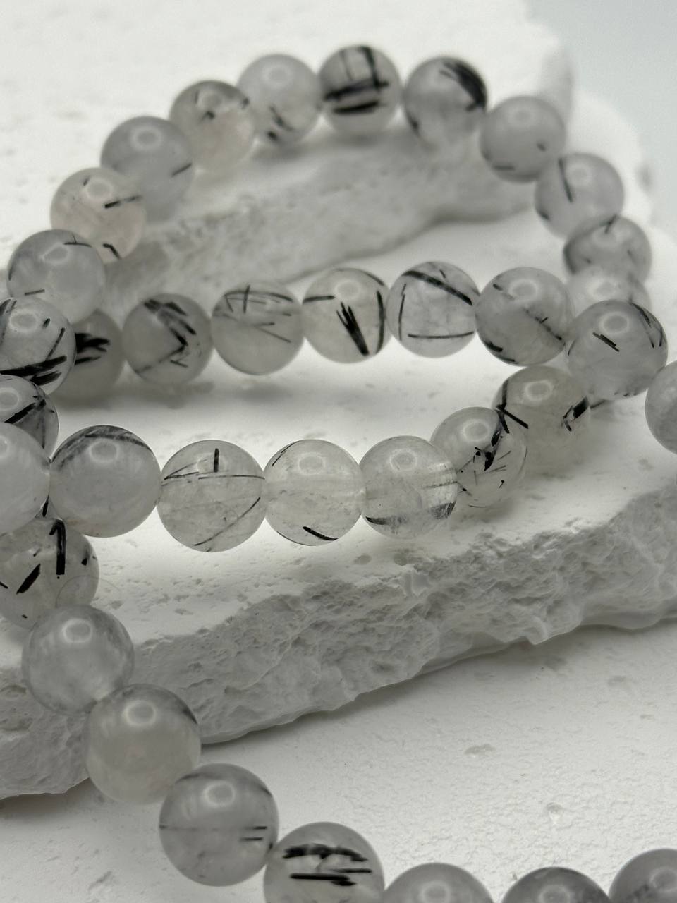 Quartz beads on white surface