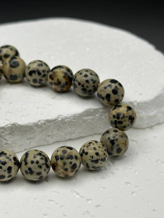 Dalmatian stone beads on white surface