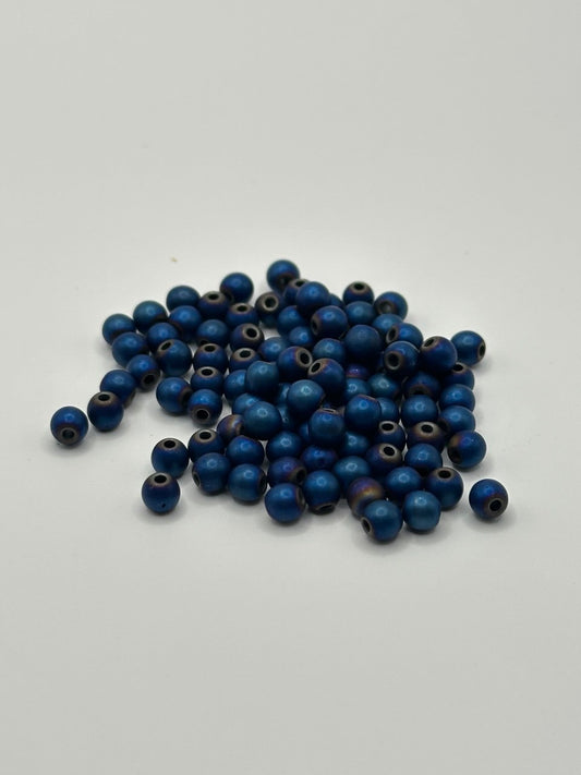 Blue matte beads on a white background