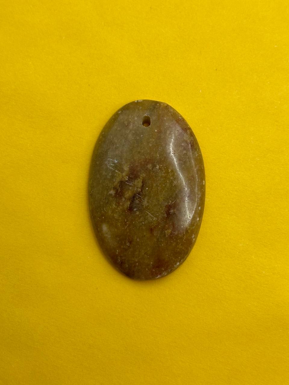 Oval-shaped stone on a yellow background