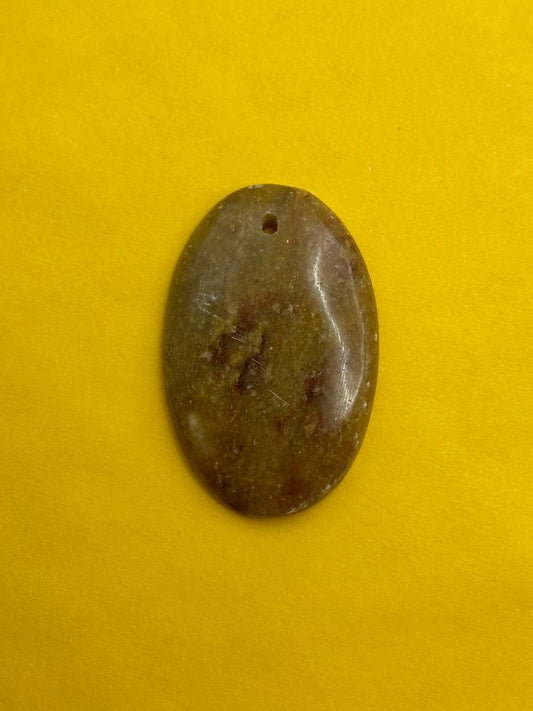 Oval-shaped stone on a yellow background