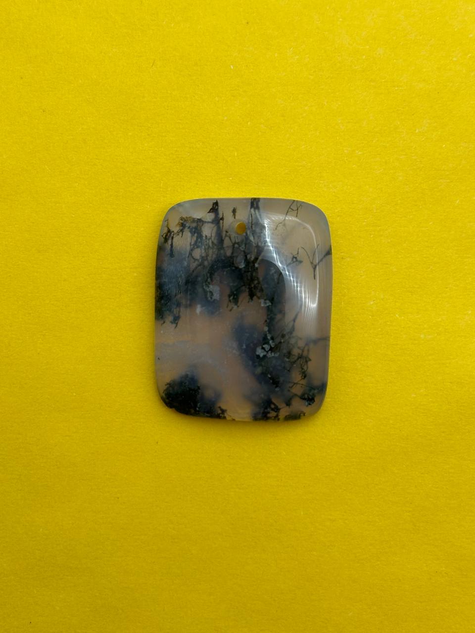 Decorative stone with blue and black patterns on a yellow background