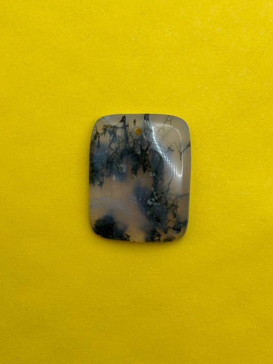 Decorative stone with blue and black patterns on a yellow background