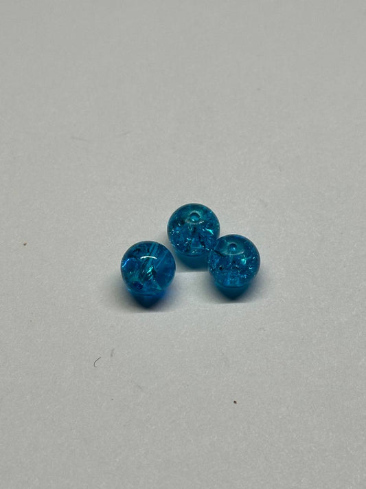 Three blue beads on a light gray background