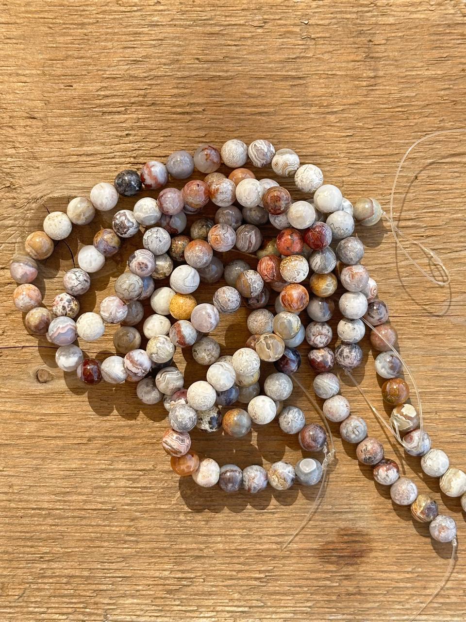 Multicolored crazy lace agate on a wooden surface