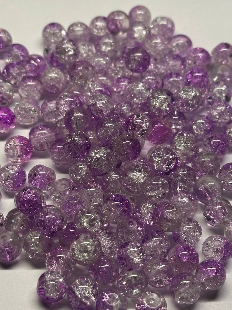 Purple and clear beads on a white background