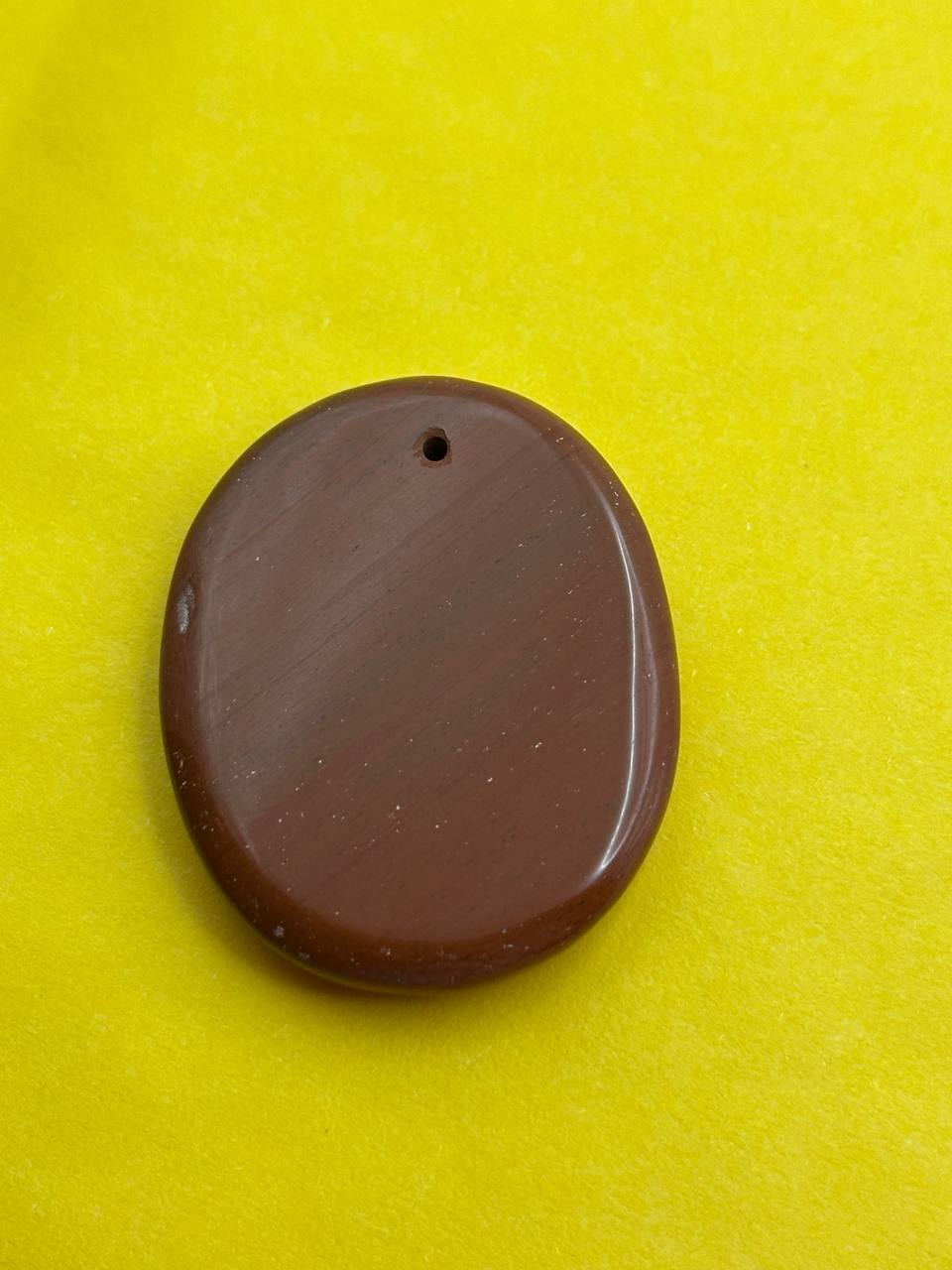 Brown oval stone on a yellow background