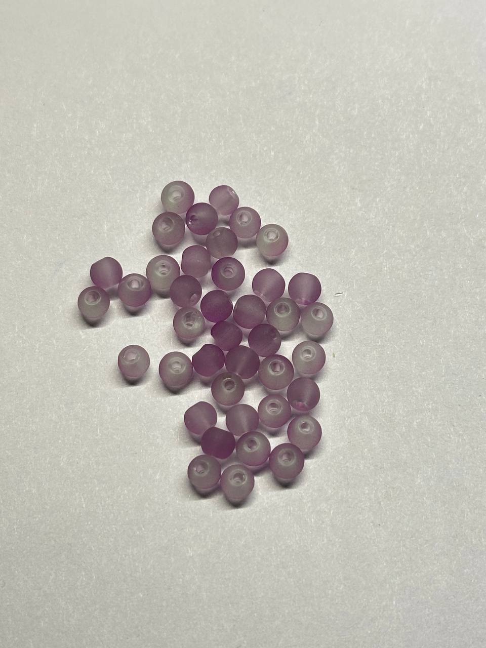 Light violet beads on a light gray background