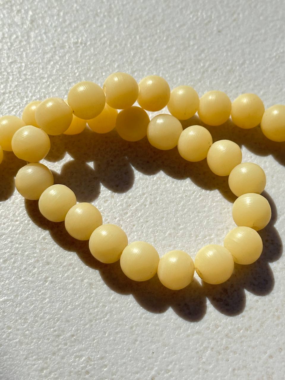 yellow matte finish calcite 11m beads on white surface