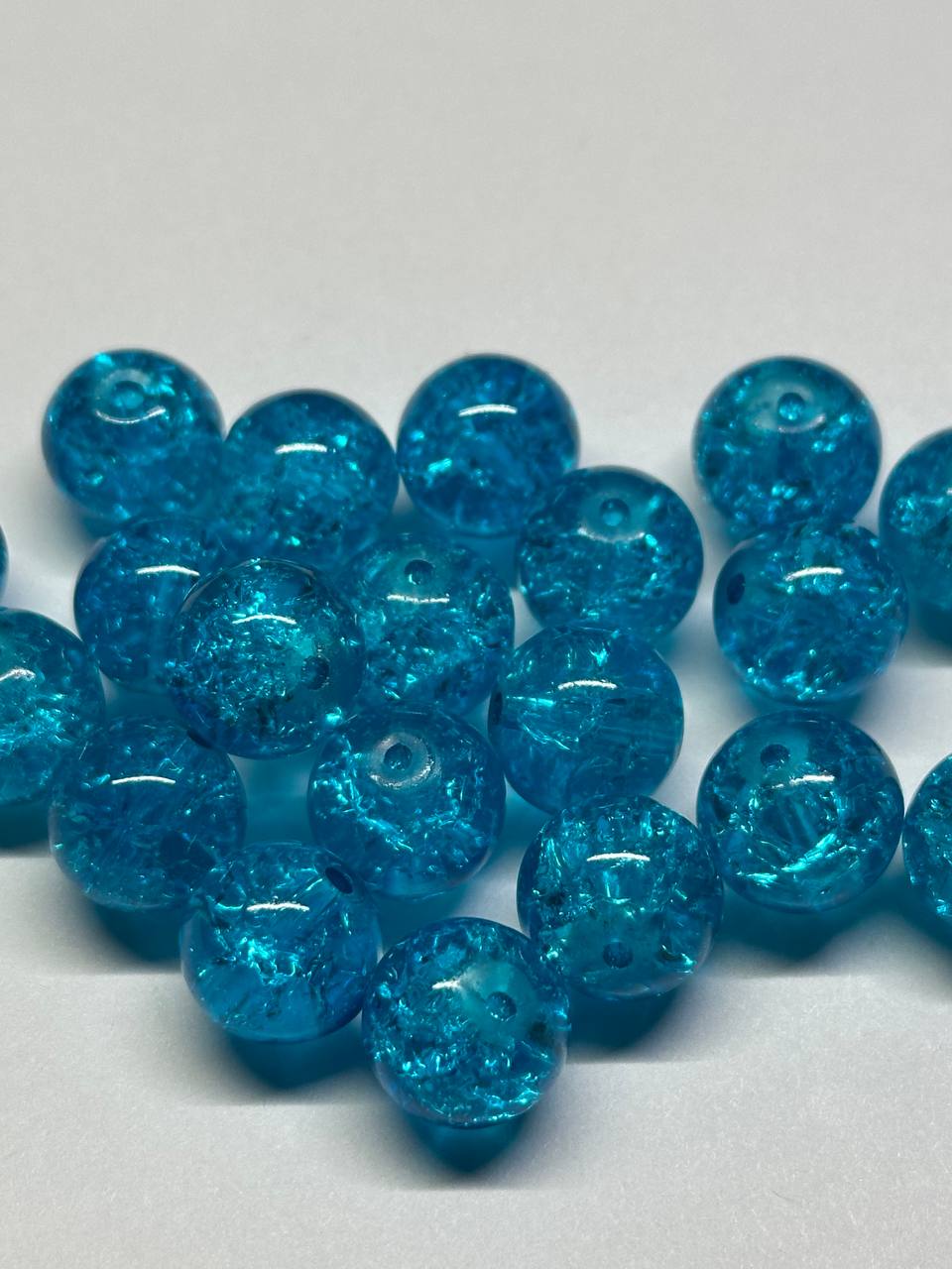 Blue glass beads on a white background