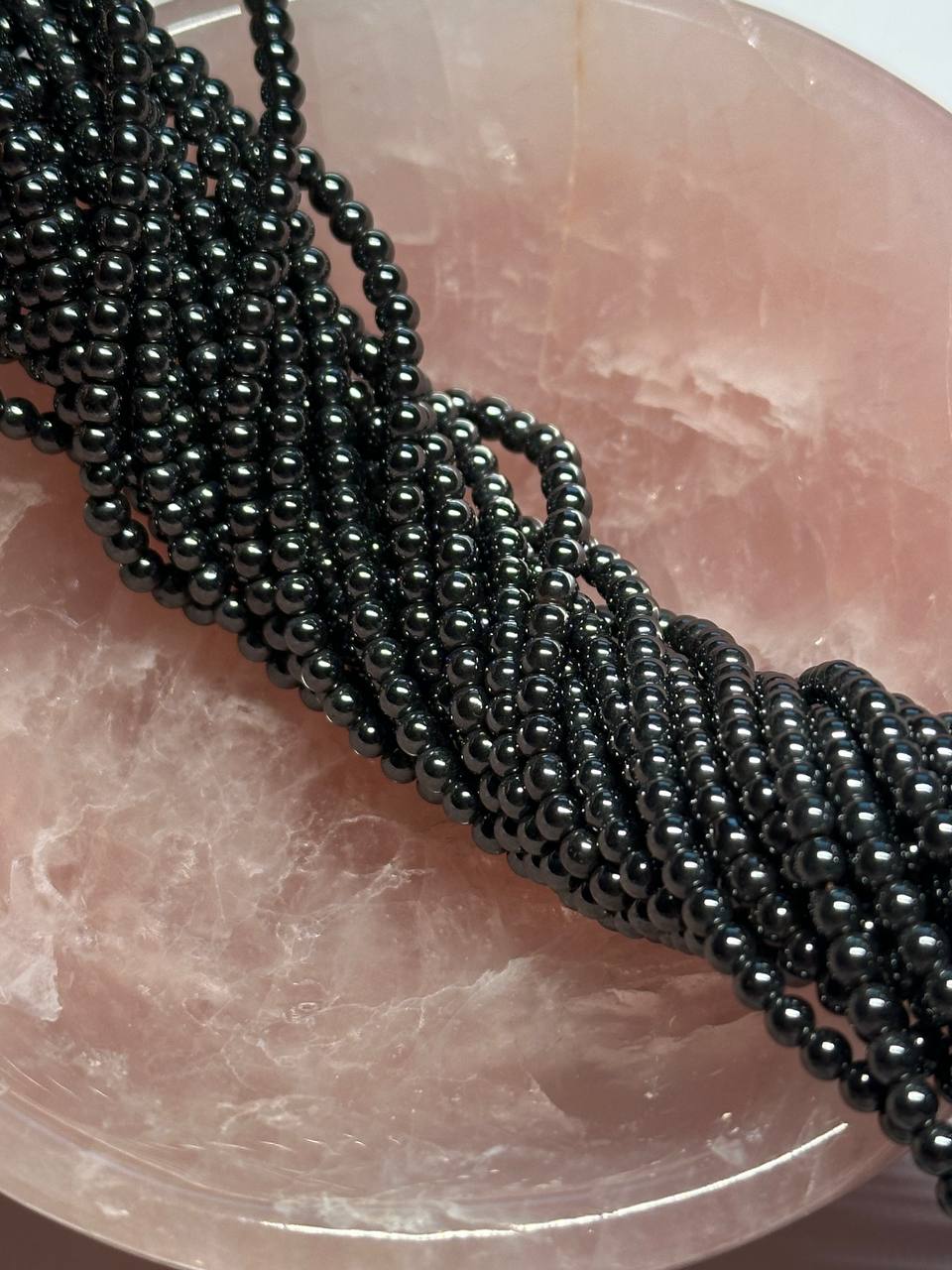 black hematite beads in pink bowl