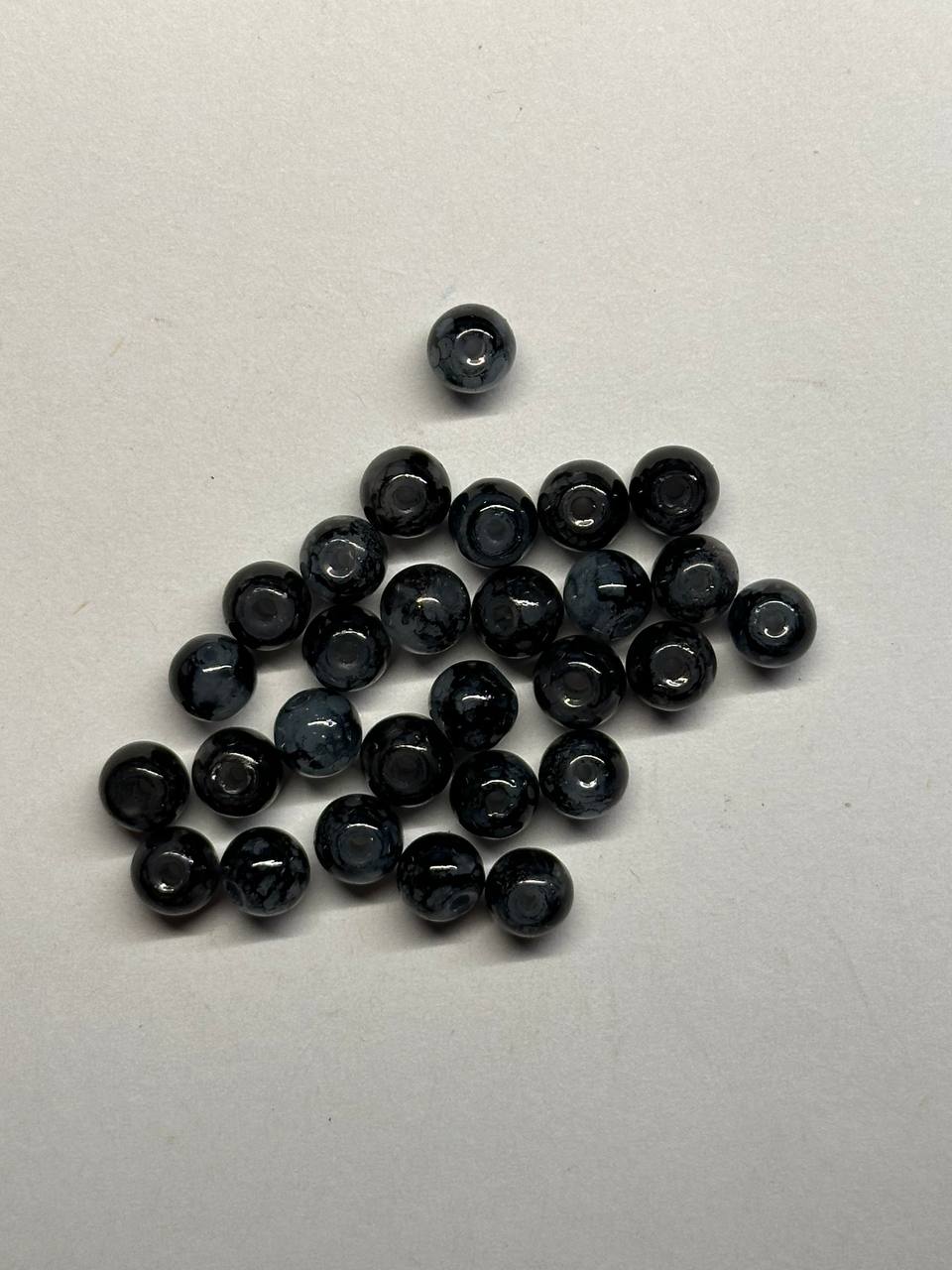 Collection of black beads on a white background