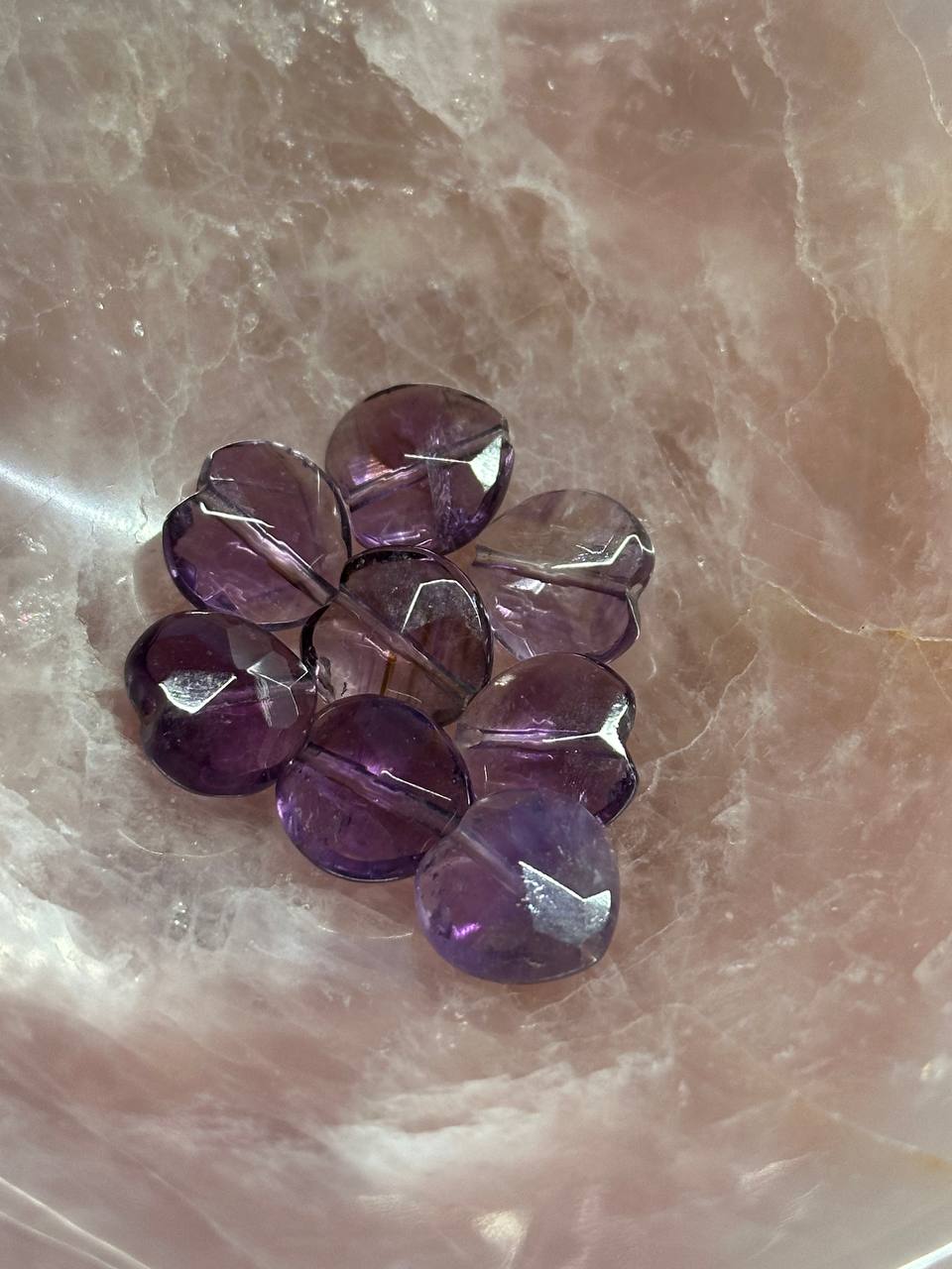 Purple beads on a textured pink surface