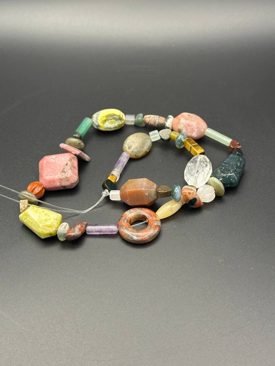 Colorful beaded necklace on a gray background