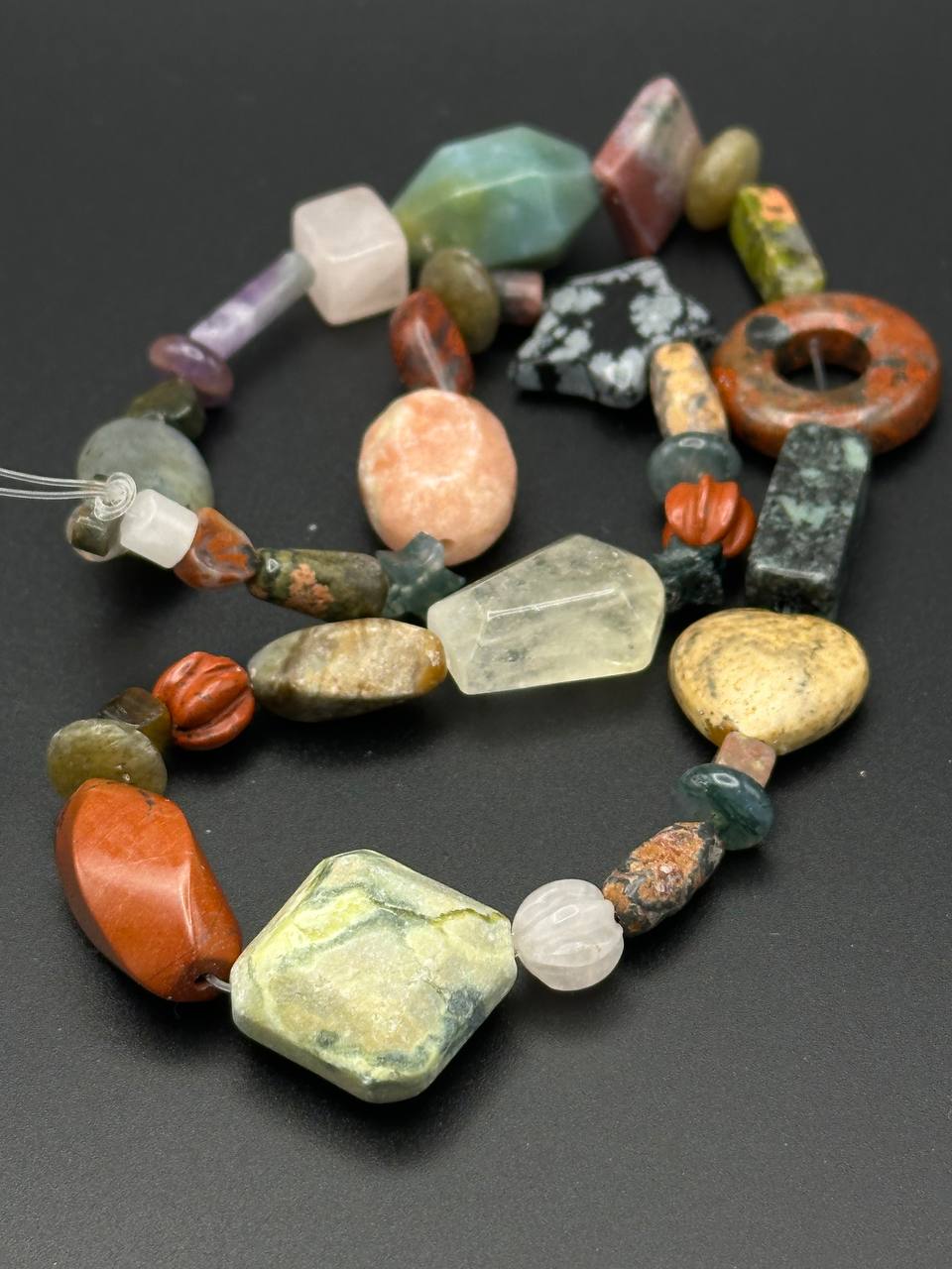 Necklace with multicolored beads on a dark background