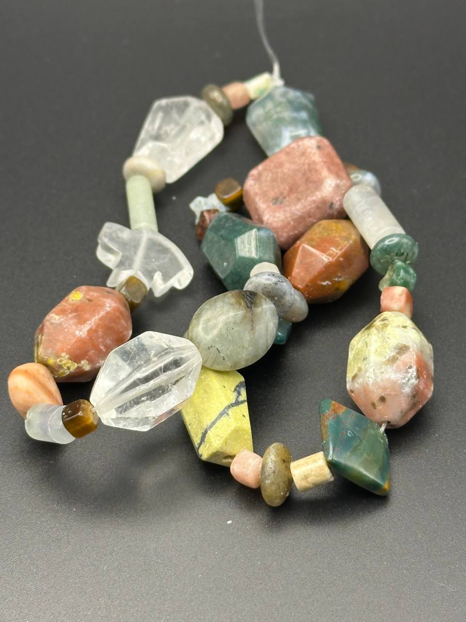 Multicolored stone bead necklace on a dark background