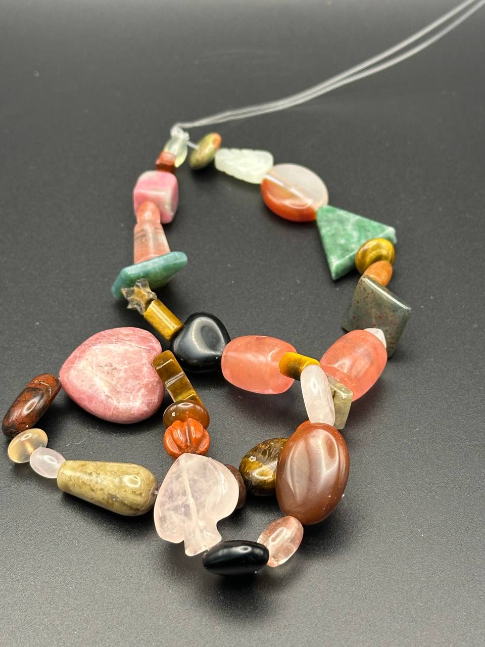 Necklace with multicolored beads on a dark background