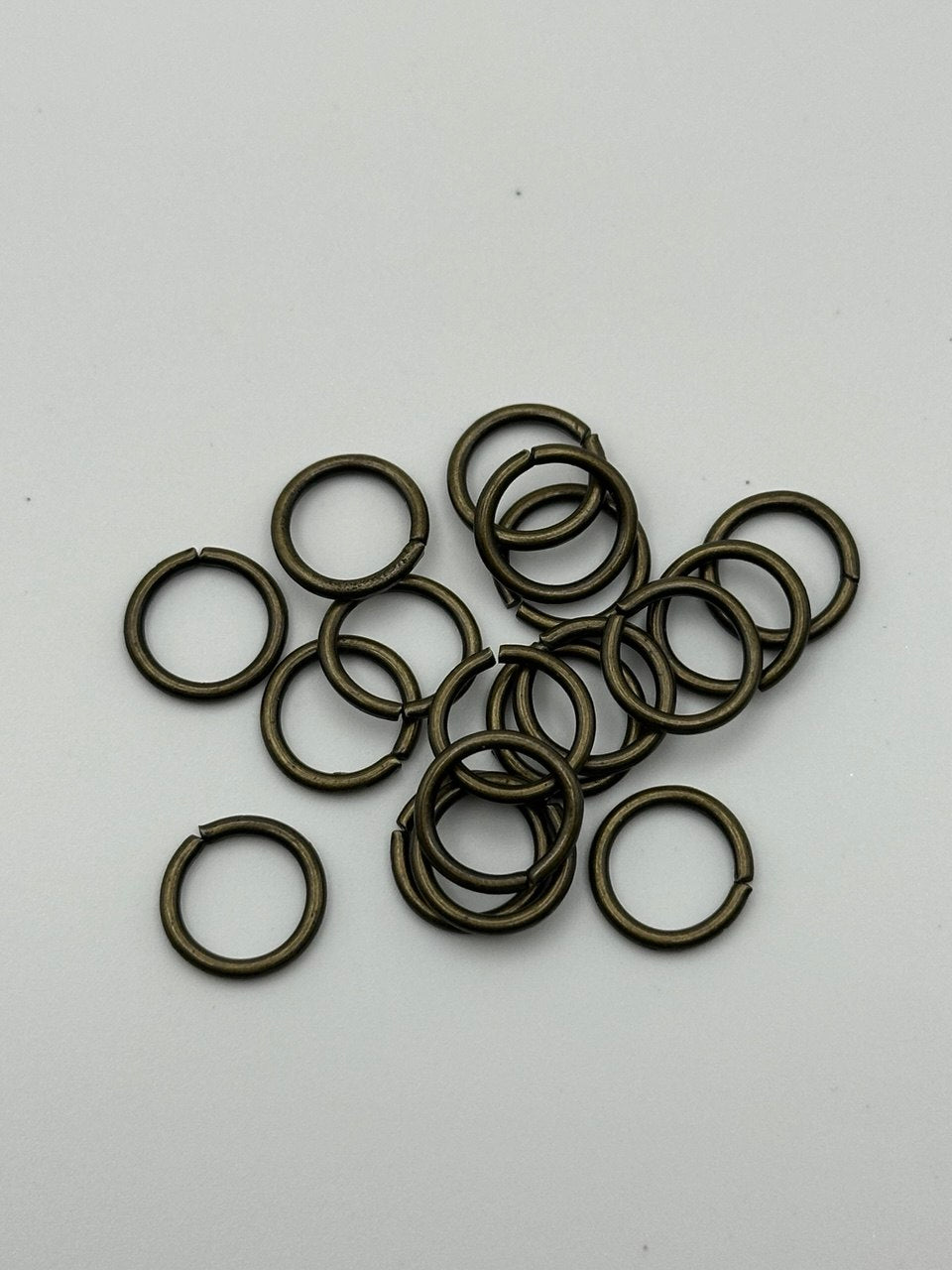 Brass jump rings on a white background