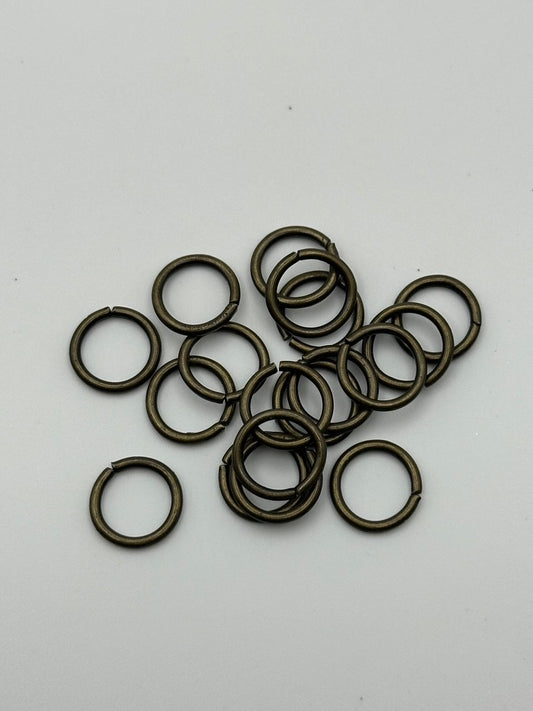 Brass jump rings on a white background
