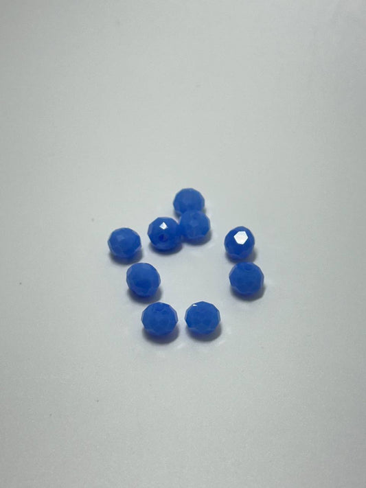 A set of nine light blue faceted rondelle beads on white background