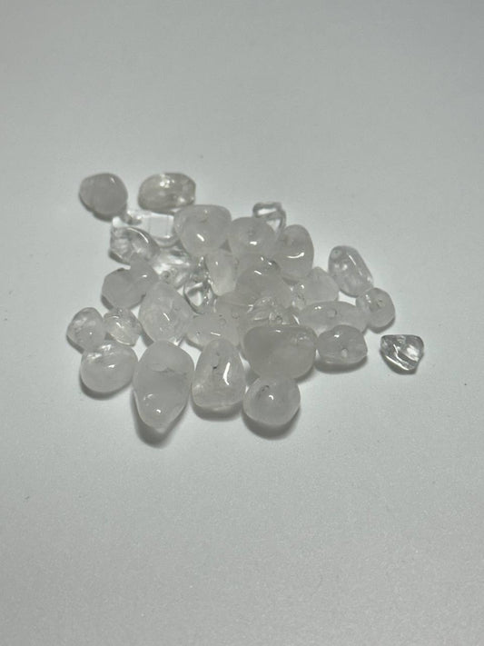 A small pile of clear quartz chips on white background
