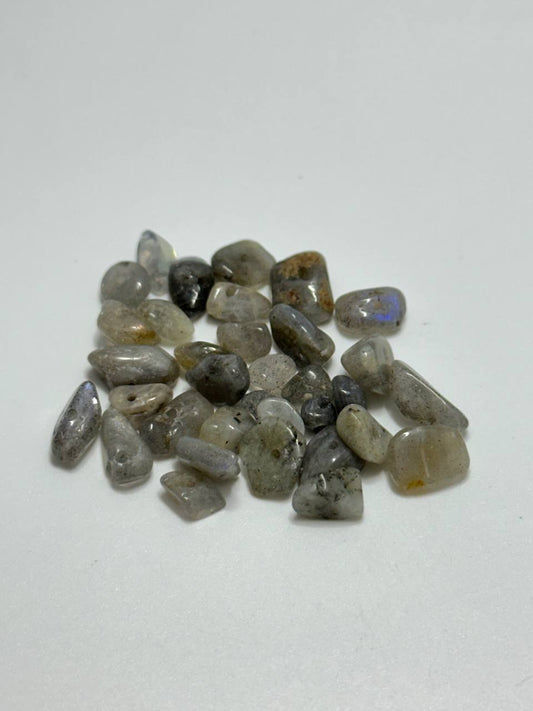 A small pile of labradorite chip beads on white background